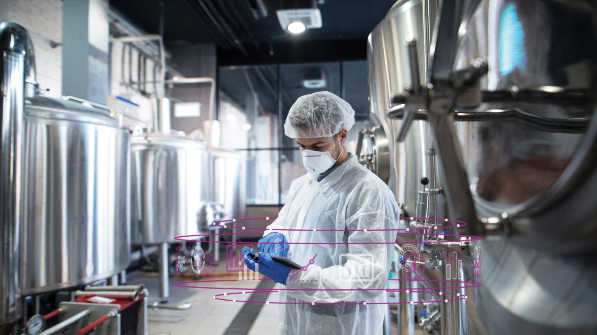 Life Sciences - Man in clean room PPE mask gloves booffant hat coverall lab coat biotech 