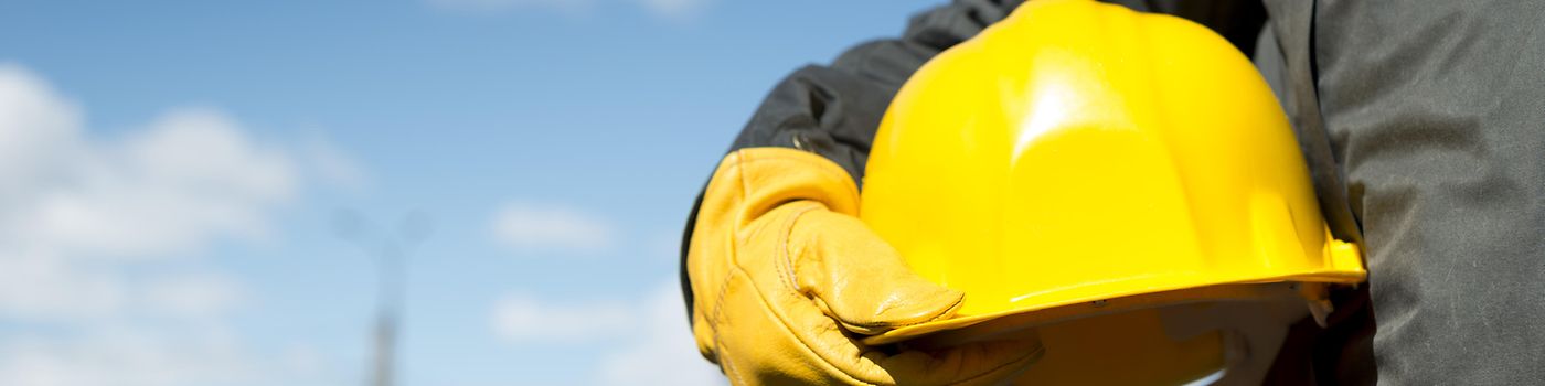 PPL builder with yellow hardhat and gloves, selective focus
